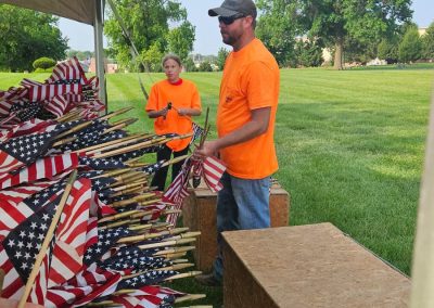 volunteers ready to place a lot of american flags